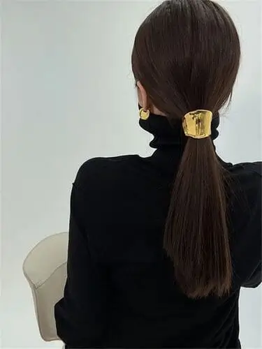 Chic gold ponytail holder for fall, perfect for adding a sophisticated sparkle to your look and complementing your autumn outfits with a touch of glam.