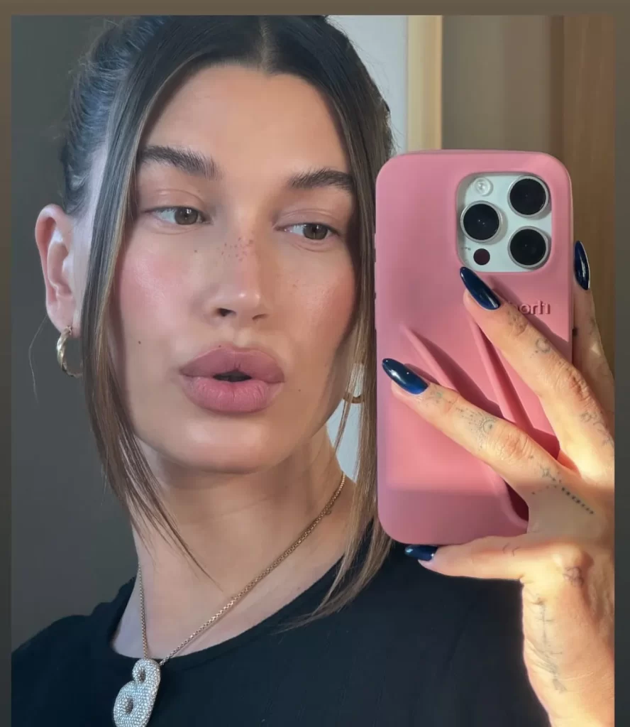 Hailey Bieber rocking trendy navy blue nails, the perfect fall manicure idea for 2024. Get inspired by her chic nail look and find similar nail polish shades in our latest blog post