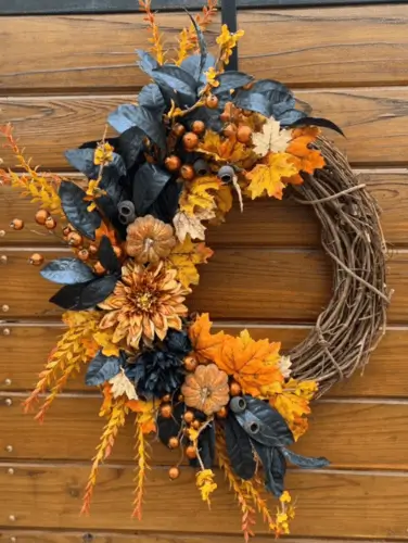 Blue, orange, and yellow fall wreath featuring vibrant seasonal colors with lush greenery. Perfect for adding a bold and cheerful touch to your autumn decor.