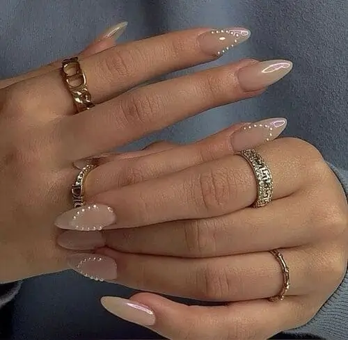 Elegant pearl nails with delicate pearl accents for a sophisticated fall look.