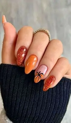 Elegant fall pumpkin spice nails featuring warm, autumnal hues and chic designs perfect for the season.