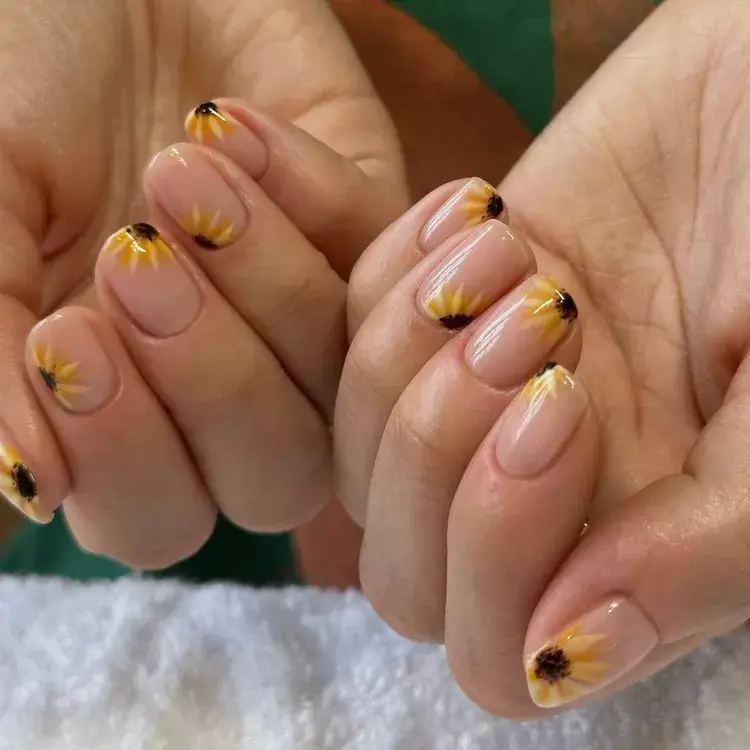 Bright sunflower nail design manicure with vibrant yellow petals and green accents, perfect for a cheerful and nature-inspired 