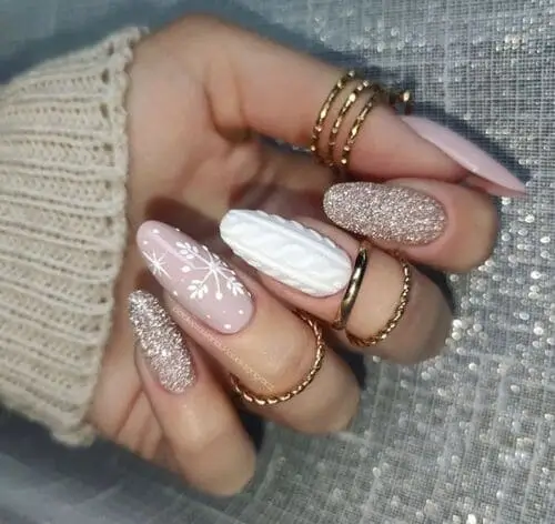 Winter Wonderland-inspired nails for 2024, featuring glittery snow, falling snowflakes, and cozy knit sweater patterns. Perfect for a festive, wintery manicure that captures the magic of the season.