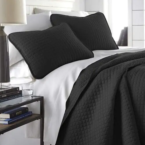 Luxurious black quilt and pillowcase set for a modern bedroom look, perfect for adding sophistication and comfort. Available on Amazon for easy purchase.