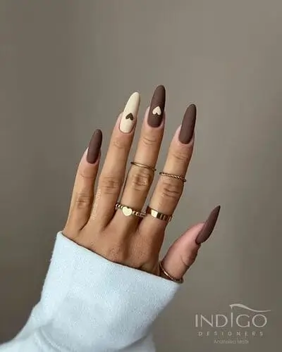 Cute and trendy brown and white matte nails with alternating tiny hearts