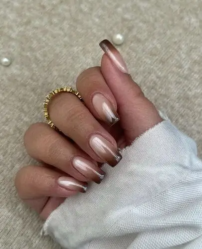 Stunning brown and white ombre nails with a chrome finish, ideal for a chic and glossy manicure look.