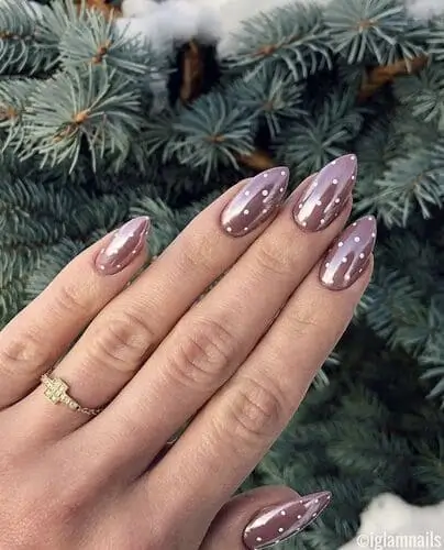 Trendy brown and white polka dot nails with a glazed donut chrome finish—perfect nail art inspiration for a stylish, eye-catching manicure.