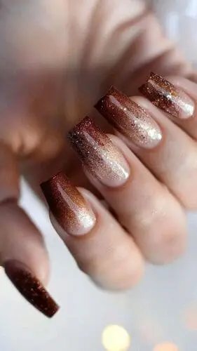 Beautiful brown and white ombre glitter nails—stunning nail art inspiration for a glamorous, eye-catching manicure.