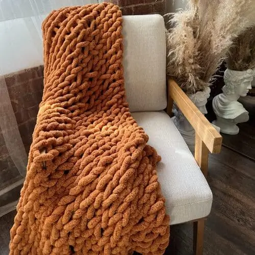 Soft and chunky autumn-colored throw blanket that adds warmth and style to your vintage-inspired bedroom decor. Available on Amazon for a perfect seasonal touch.