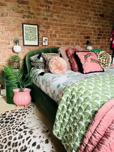 Eclectic vintage bedroom with bold green, pink, and leopard print decor, featuring unique patterns and vibrant colors to create a personalized, stylish space.