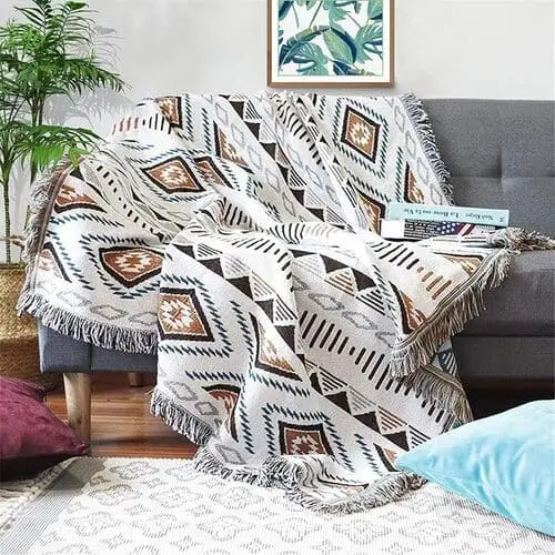 Cozy western boho blanket with earthy tones and tribal patterns, perfect for adding warmth and style to your western-inspired boho bedroom—available on Amazon.