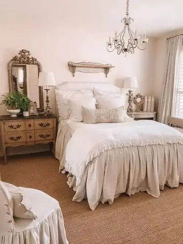 Elegant French country style bedroom with vintage touches, featuring soft cream tones, antique furniture, and floral accents. Perfect bedroom inspiration for a timeless, romantic look.