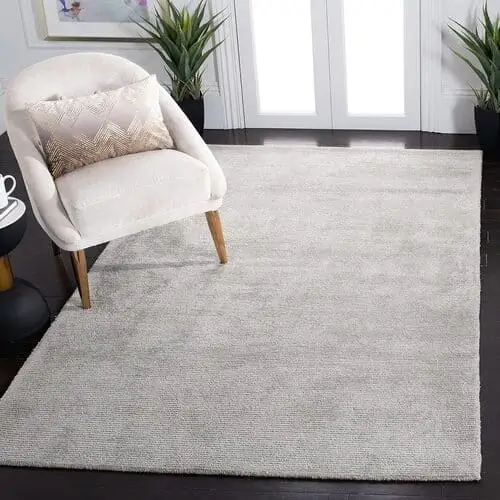 Grey handmade wool and viscose rug, perfect for high-traffic areas in living rooms or bedrooms, adding durability and style. Available for purchase on Amazon.