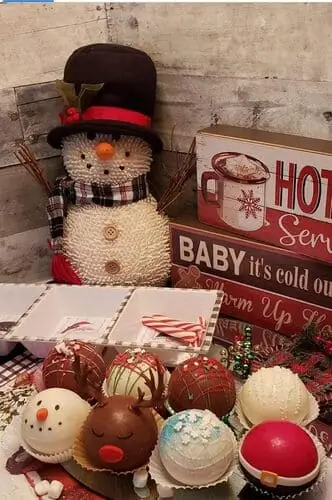 Hot cocoa bomb station with festive chocolate bombs, toppings, and holiday decor – a fun and trendy addition to your Christmas hot cocoa bar setup.