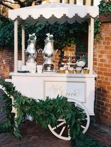 Elegant hot cocoa cart at a wedding, featuring gourmet hot chocolate, decorative toppings, and beautiful wedding-themed decor – perfect for winter celebrations.