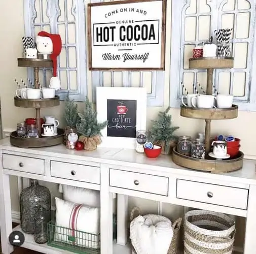 Festive hot cocoa bar setup on a side table with mugs, toppings, marshmallows, and holiday decor – perfect for Christmas gatherings and cozy winter nights.