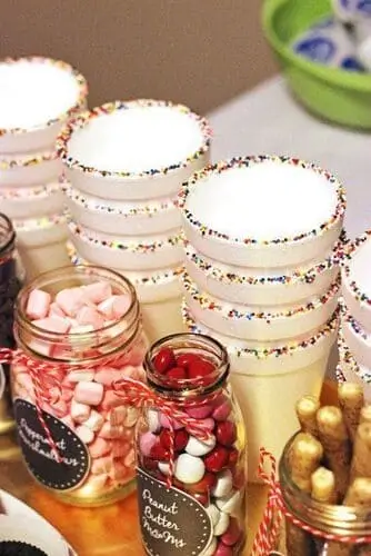 Colorful party cup with a sprinkle rim, perfect for a kids' hot cocoa bar – a fun and festive touch for winter parties and holiday celebrations.