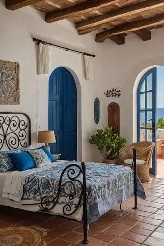 Mediterrenean bedroom with terracotta floor, arched doorways, iron bedrframe, and raw wood beams.