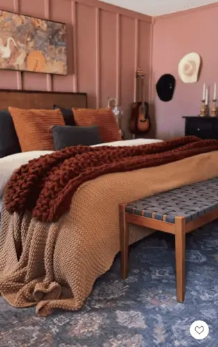 Cozy and inviting vintage-inspired bedroom with warm autumn hues, featuring earthy tones and rich textures, perfect for fall bedroom decor ideas.