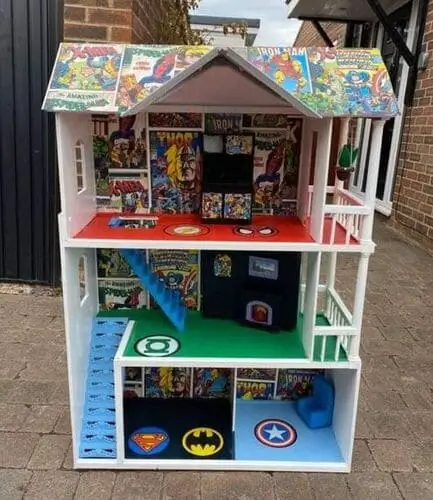 DIY comic-themed playhouse for boys made from a dollhouse with comic book images decorating the walls for an action-packed play space.