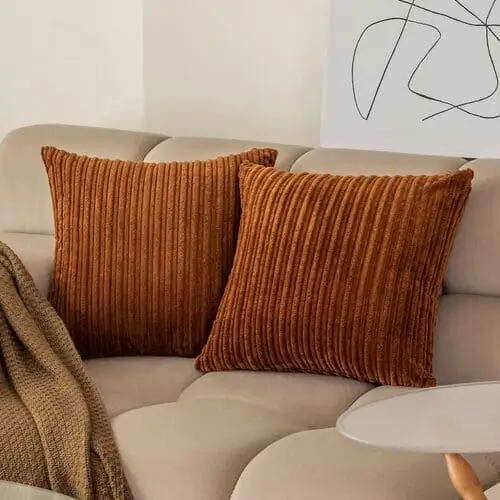 Luxurious fall-colored throw pillows with rich textures, perfect for creating a cozy and inviting atmosphere in your bedroom this autumn. Shop these pillows on Amazon