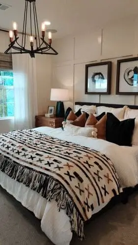 Western boho bedroom inspiration featuring earthy tones, leather accents, woven textures, and rustic wood furniture—perfect for adding a cozy, modern southwestern vibe.