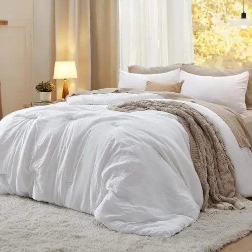 Luxurious white comforter set for a beautiful, cozy bedroom, featuring soft, high-quality fabric to create a clean, elegant look