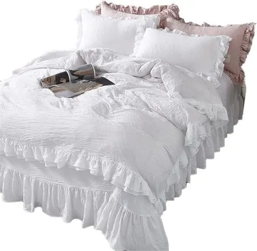 Beautiful ruffled French country bedding set in soft white, available for purchase on Amazon. Ideal for adding a touch of vintage charm and elegance to your bedroom