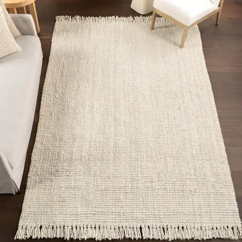 Light natural sandy woven rug for a coastal bedroom, available on Amazon, perfect for adding texture and warmth to your beach-inspired space.