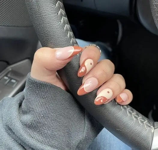 Stylish brown and white yin-yang nails—a trendy manicure representing balance and unity with an earthy twist.