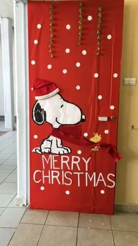 Red Snoopy Christmas door with bells, festive holiday decor idea for Peanuts fans and Christmas door decoration ideas