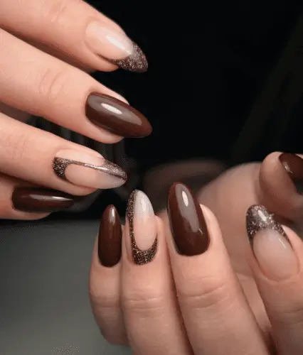 Dark walnut brown nails with chic brown glitter accents, featuring French tip and center sweep designs for a stylish, modern manicure.