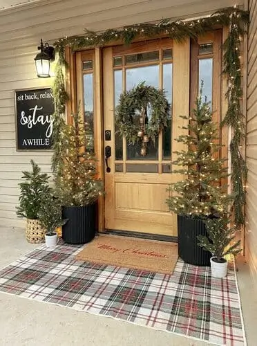 Modern farmhouse Christmas door decorations featuring a faux cedar wreath adorned with twinkly lights; classic holiday decor with a rustic charm, perfect for adding warmth to an entryway during the festive season