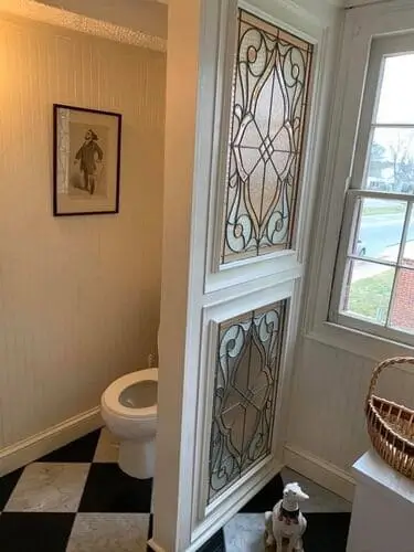 Glass privacy divider in a modern bathroom, creating a sleek separation for the toilet area while maintaining an open and spacious feel with natural light flow.