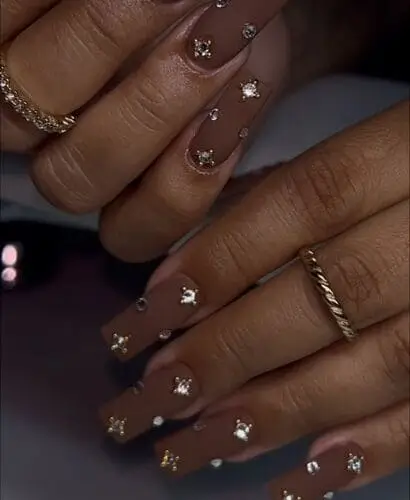 Elegant brown matte nails with rhinestone accents—chic nail art inspiration for a glamorous, stylish manicure.