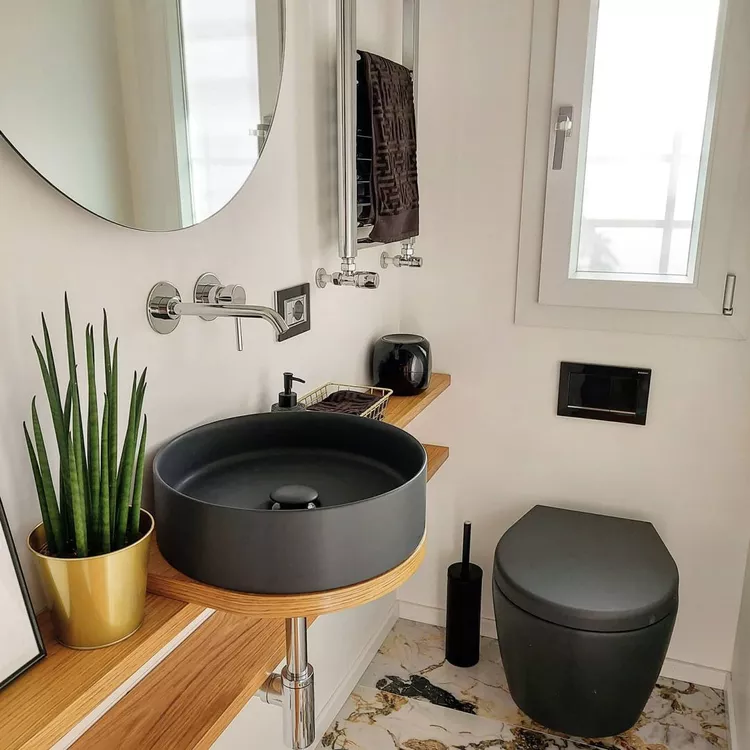 Minimalist design for small narrow bathroom keeps visual clutter to a minimum to make the space more breathable