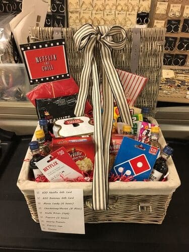 Movie night Christmas basket for men with restaurant gift cards, beer, snacks, and movie gift cards