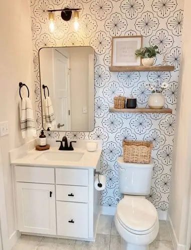 Floral medallion wallpaper accent wall in a narrow bathroom, adding elegance and visual interest."