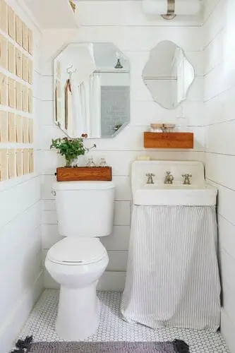 Skirted sink in a narrow bathroom with hidden storage underneath, combining style and practicality for small spaces.