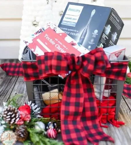 Bluetooth earbuds in a tech gift basket for men’s Christmas gifts
Portable charger and phone stand for a tech-savvy holiday gift idea
Electric toothbrush and Apple Watch in a Christmas gift basket for him