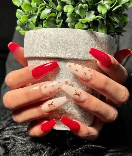 Valentine’s Day nails featuring Louis Vuitton-inspired designs with pink and red accents for a chic and luxurious look.