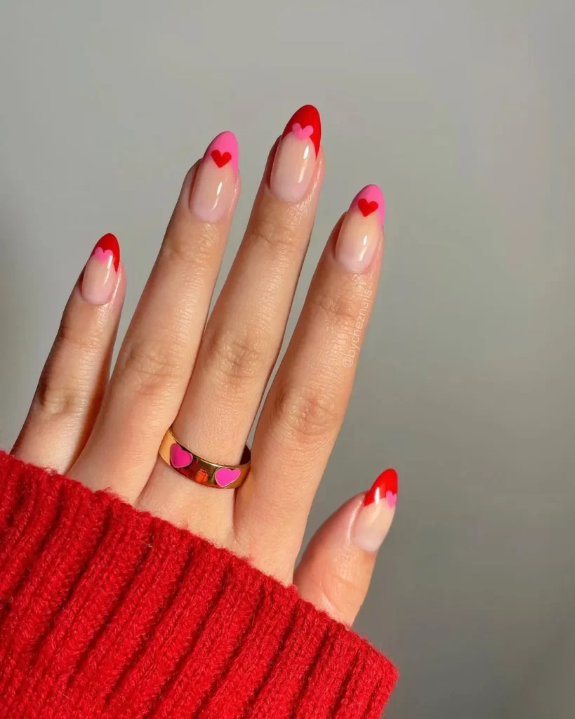 Valentine's colorblock French tip nails with a mix of pink, red, and white for a playful and modern take on a classic design.