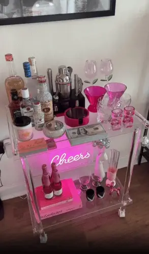 Cute colorful bar cart for apartment decor, adding a stylish pop of color while offering functional storage for drinks, glassware, and decorative accents.