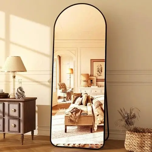 Large arched floor mirror for cute apartment decor, ideal for reflecting light and creating the illusion of a bigger, brighter space.