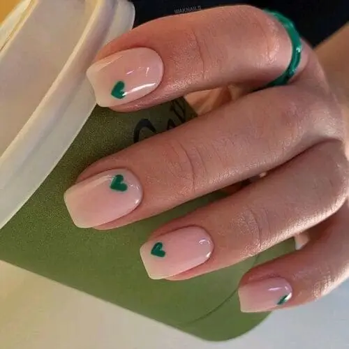 Valentine’s nails featuring dainty green hearts for a fresh and subtle twist on classic romantic nail designs.