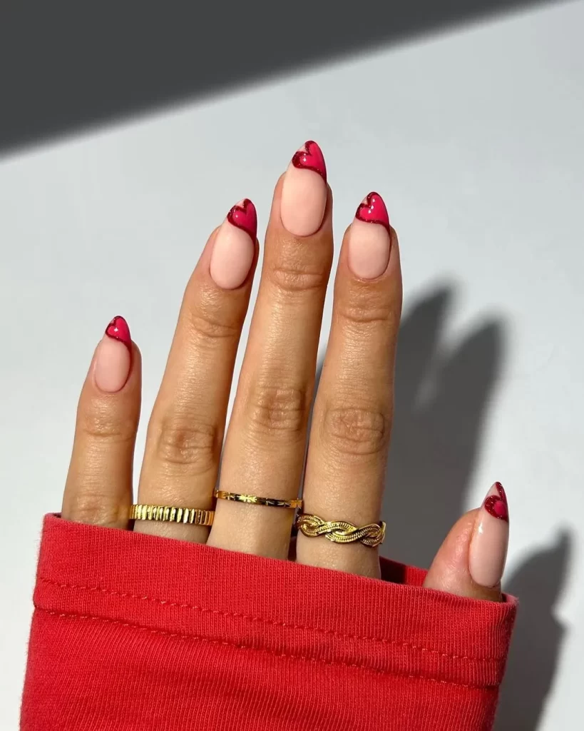 Valentine's Day nail design featuring a classic French manicure with subtle heart-shaped tips for a romantic and elegant look.