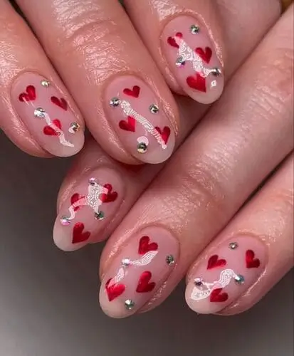 Dainty hearts with crystal accents for a chic Valentine's Day nail design. Nail stickers with heart designs available on Amazon for an easy and stylish at-home manicure.