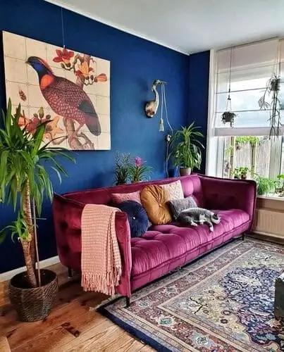 Navy blue and plum maximalist living room with rich tones, lush finishes, and jewel-toned carpet