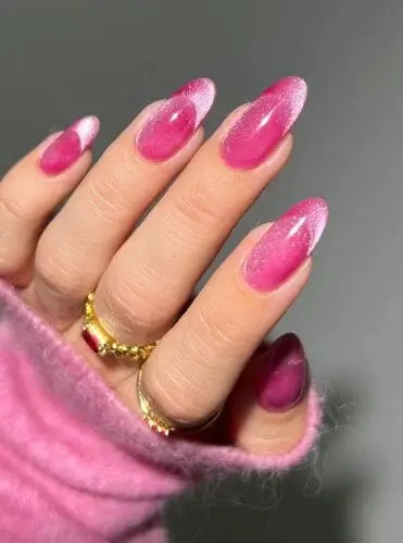 Pink dazzling cat's eye Valentine's nails with shimmer and heart accents perfect for romantic nail designs. Trendy Valentine's Day nail art featuring pink and silver hues for a stunning look.