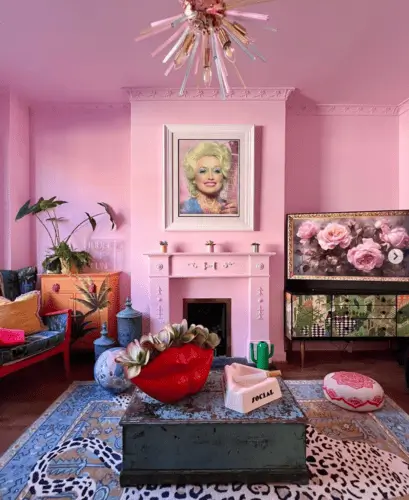 Pink maximalist living room with Dolly Parton photo and fun eclectic decor pieces